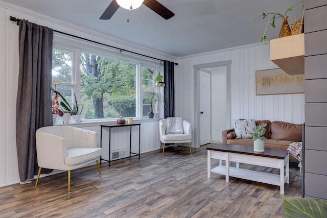 sitting room with crown molding, hardwood / wood-style floors, and ceiling fan