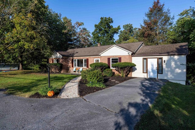 ranch-style house with a front lawn