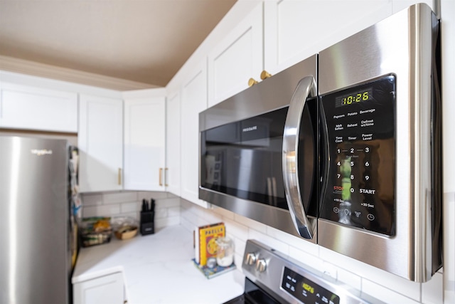 kitchen with stainless steel appliances and white cabinets