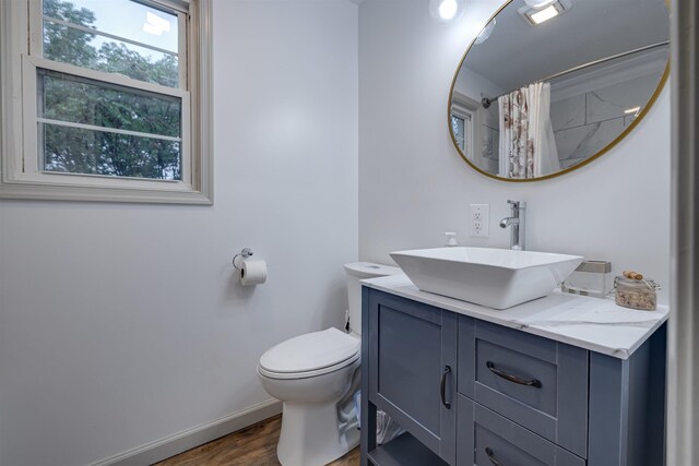 bathroom with vanity, hardwood / wood-style flooring, toilet, and a shower with shower curtain