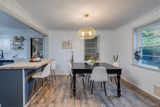 dining space with crown molding and dark wood-type flooring