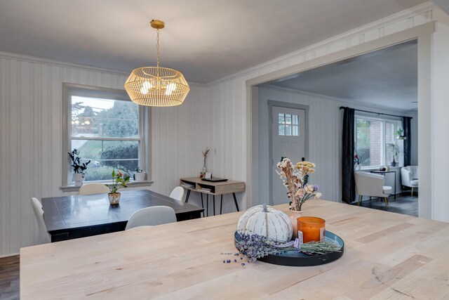 dining room featuring ornamental molding and a notable chandelier