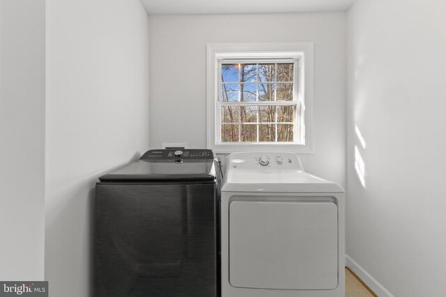 washroom with independent washer and dryer