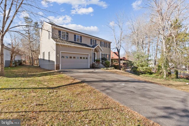 view of front facade featuring a garage and a front yard