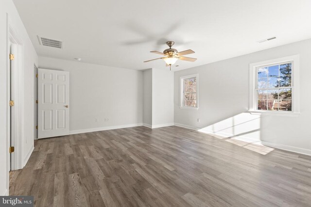 unfurnished room featuring dark hardwood / wood-style flooring and ceiling fan