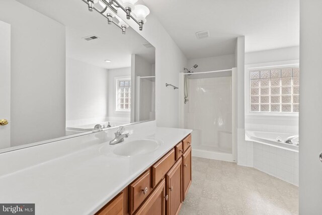 bathroom with vanity and plus walk in shower