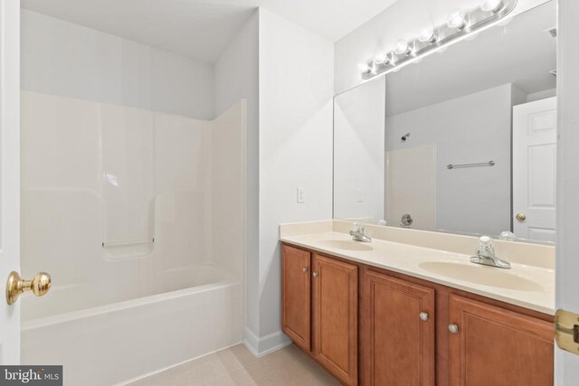 bathroom featuring shower / bathtub combination and vanity