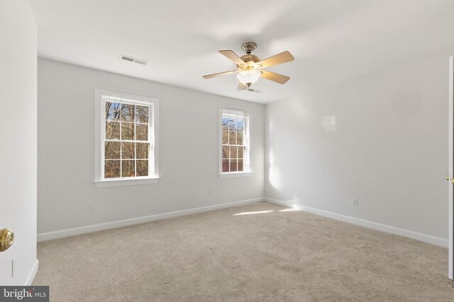 carpeted empty room featuring ceiling fan