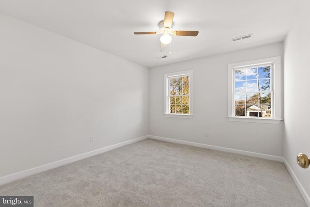 empty room with light colored carpet and ceiling fan