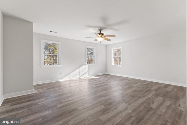 spare room featuring dark hardwood / wood-style floors and ceiling fan