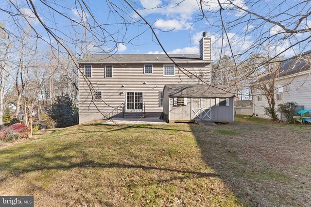 back of house with a yard and a patio area