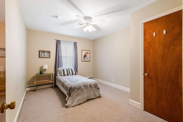 carpeted bedroom with baseboard heating and ceiling fan