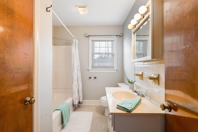 full bathroom with vanity, toilet, shower / tub combo, and backsplash