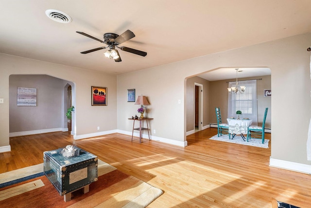 unfurnished living room with hardwood / wood-style flooring and ceiling fan with notable chandelier