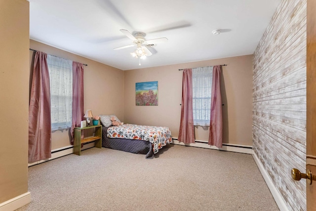 bedroom featuring a baseboard heating unit, ceiling fan, and carpet flooring