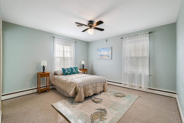 carpeted bedroom featuring a baseboard heating unit and ceiling fan