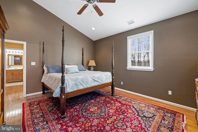 bedroom featuring ceiling fan, lofted ceiling, and light wood-type flooring