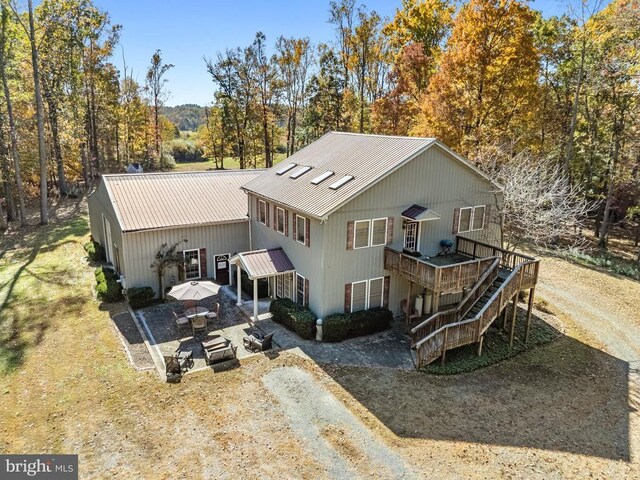 back of house featuring a wooden deck