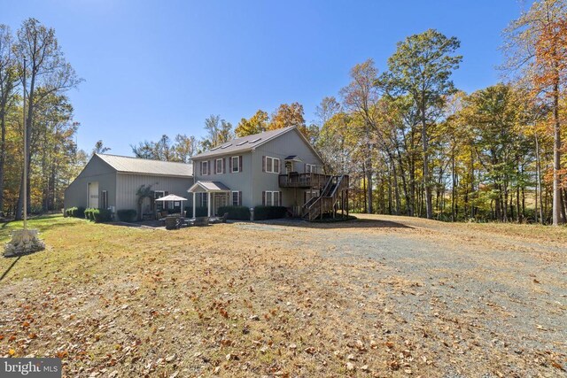 rear view of property with a wooden deck