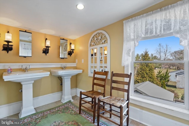 bathroom featuring tile patterned floors, baseboards, and a sink