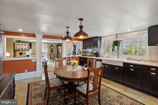 dining space featuring recessed lighting, baseboards, and decorative columns