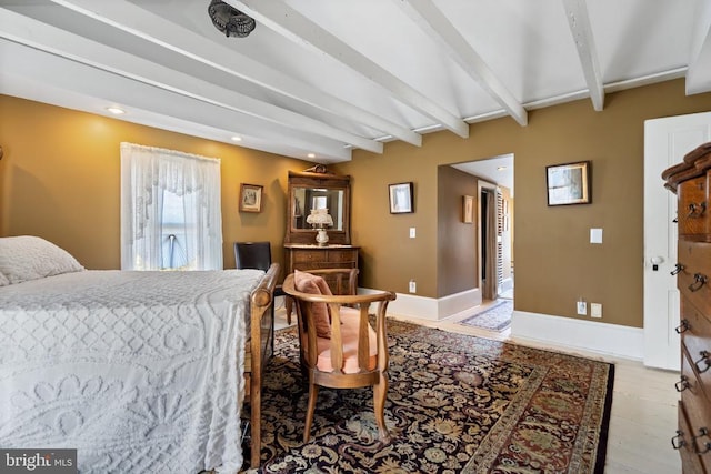 bedroom with beamed ceiling, recessed lighting, light wood-type flooring, and baseboards