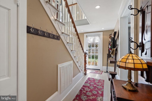 entrance foyer featuring stairway, wood finished floors, visible vents, baseboards, and recessed lighting