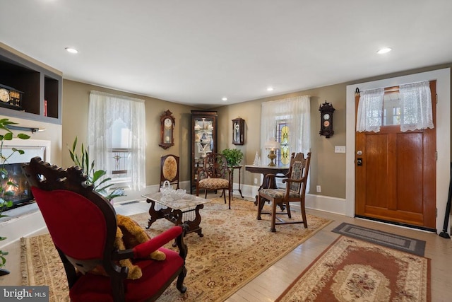 living room featuring recessed lighting, wood finished floors, and baseboards