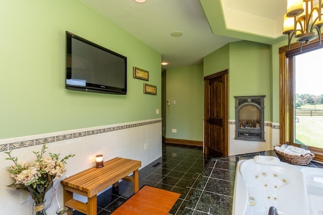 bathroom featuring a bathing tub and tile walls