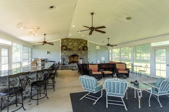 sunroom / solarium with lofted ceiling and a fireplace