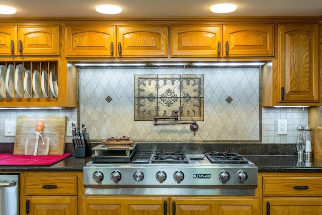 kitchen featuring backsplash, stainless steel gas stovetop, and dark stone countertops