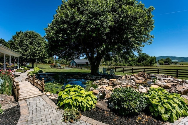 view of yard featuring a mountain view and a rural view