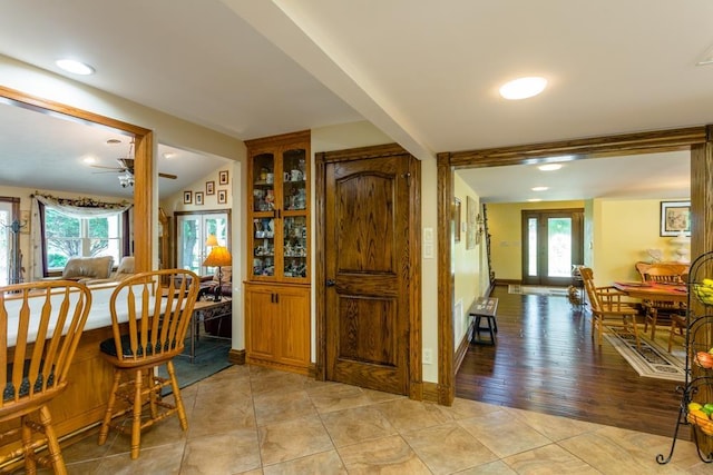 interior space with lofted ceiling, french doors, ceiling fan, and light tile patterned flooring