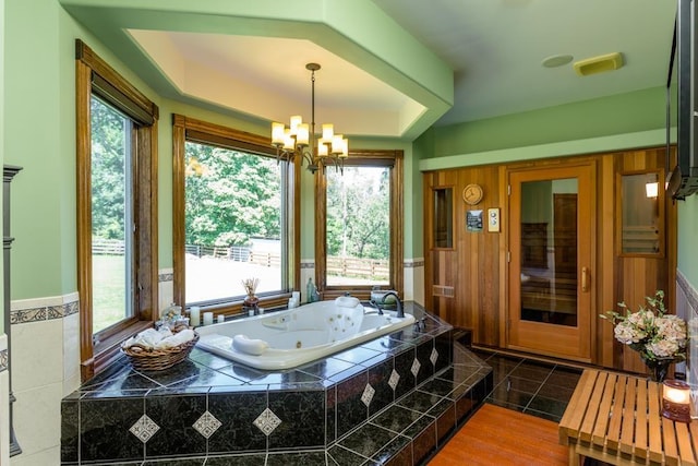 interior space with a notable chandelier and a tray ceiling