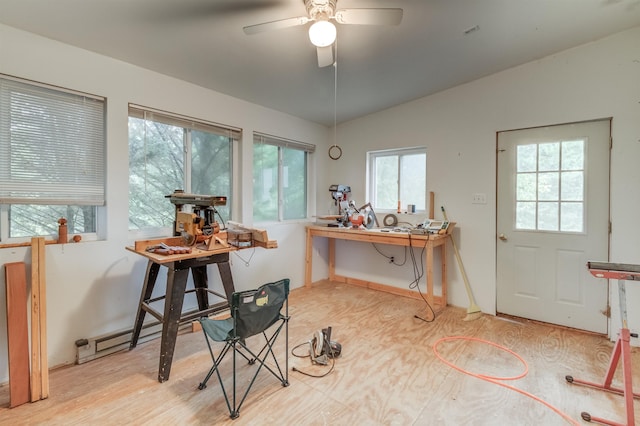 dining space featuring vaulted ceiling, plenty of natural light, a baseboard heating unit, and ceiling fan