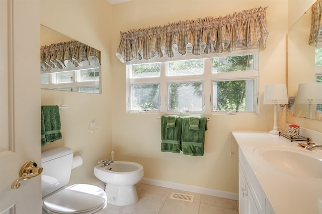 bathroom featuring a bidet, vanity, tile patterned floors, and toilet