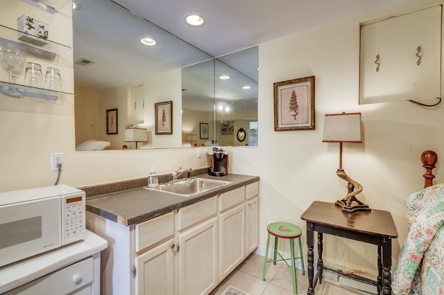 kitchen with sink and light tile patterned flooring