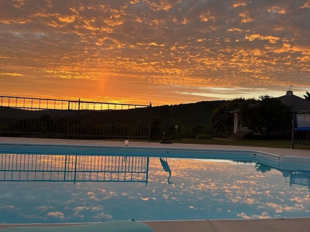 view of pool at dusk