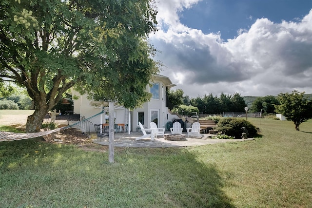 view of yard featuring an outdoor fire pit and a patio area