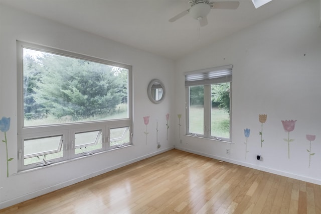 unfurnished room featuring ceiling fan, lofted ceiling, and light hardwood / wood-style flooring