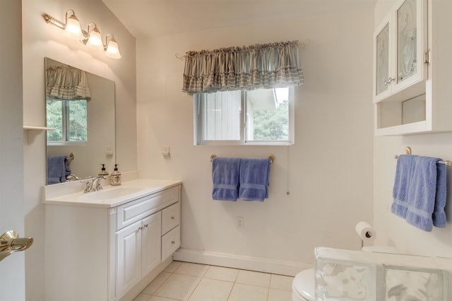 bathroom with tile patterned flooring, vanity, and toilet