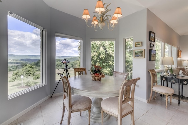 dining area with an inviting chandelier, a mountain view, and light tile patterned floors