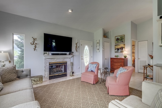 tiled living room featuring a high end fireplace and vaulted ceiling