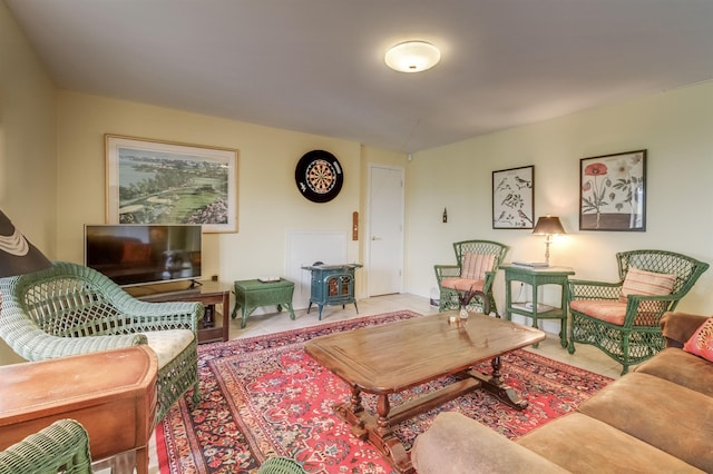 tiled living room featuring a wood stove