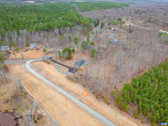 drone / aerial view featuring a wooded view