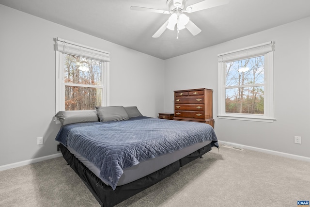 bedroom with a ceiling fan, visible vents, carpet, and baseboards