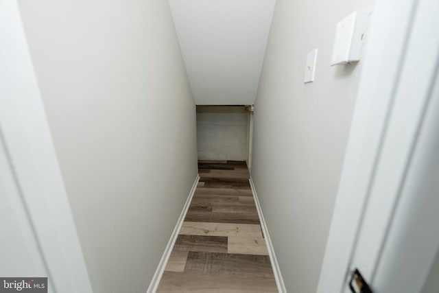 stairway featuring baseboards and wood finished floors