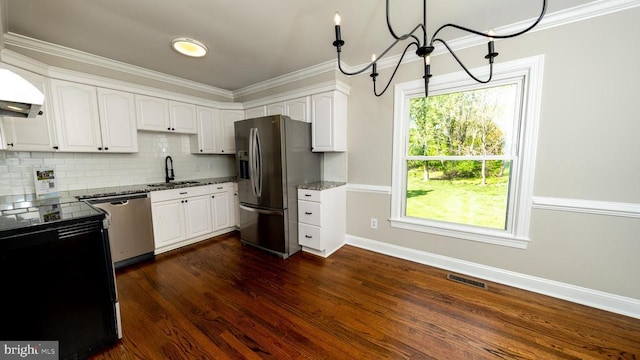 kitchen with visible vents, dark stone counters, white cabinetry, a sink, and stainless steel appliances