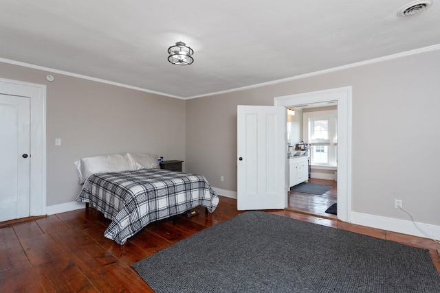 bedroom featuring crown molding, baseboards, wood-type flooring, and visible vents