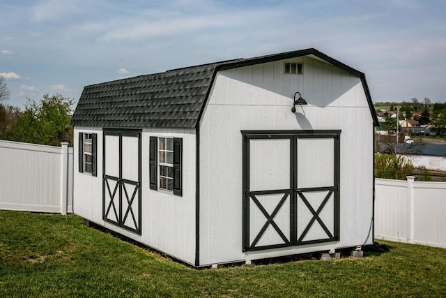 view of shed featuring fence